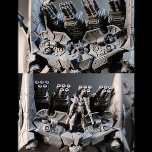 May include: A detailed, two-part image of a gray, futuristic robot model. The top section showcases multiple gun barrels, while the bottom section features a smaller robot figure with weapons, set against a dark background. The model has intricate mechanical details.