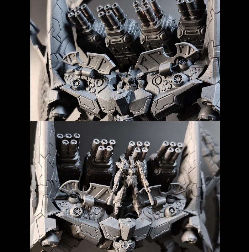May include: A detailed, two-part image of a gray, futuristic robot model. The top section showcases multiple gun barrels, while the bottom section features a smaller robot figure with weapons, set against a dark background. The model has intricate mechanical details.