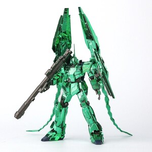 May include: A metallic green robot model with a large rifle and wing-like structures extending from its back. The robot has intricate details and is posed against a white background. The model is a collectible item.
