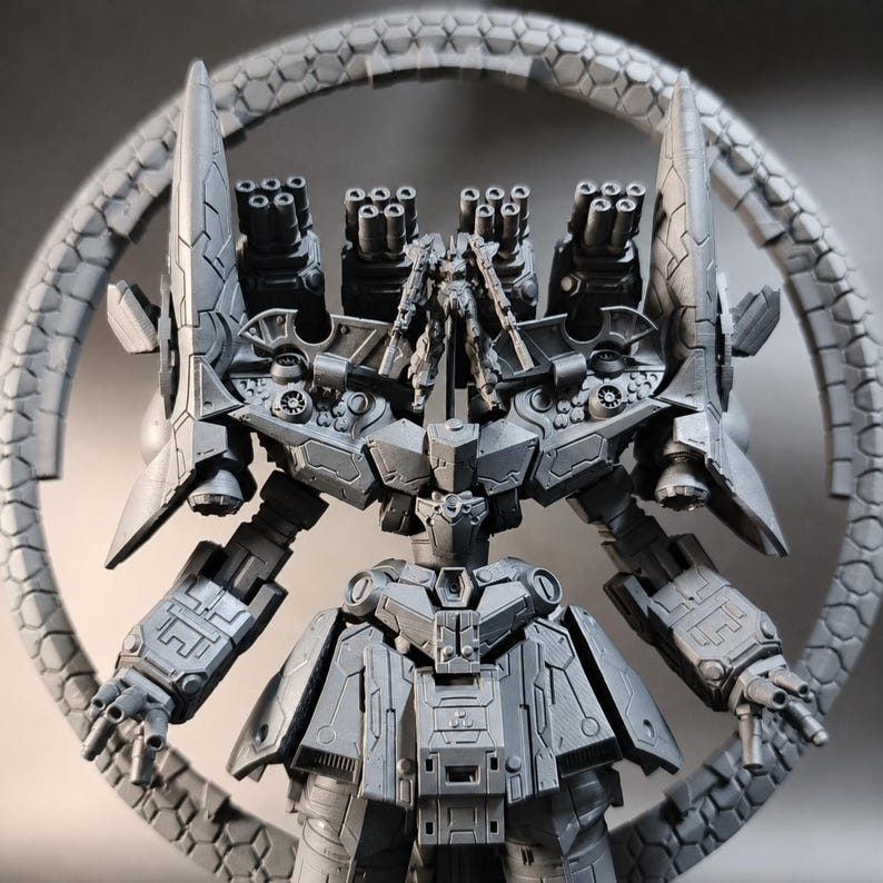 May include: A gray, detailed model of a futuristic robot with multiple cannons and a circular, segmented structure behind it. The robot has intricate armor plating and articulated arms, showcasing a complex design.