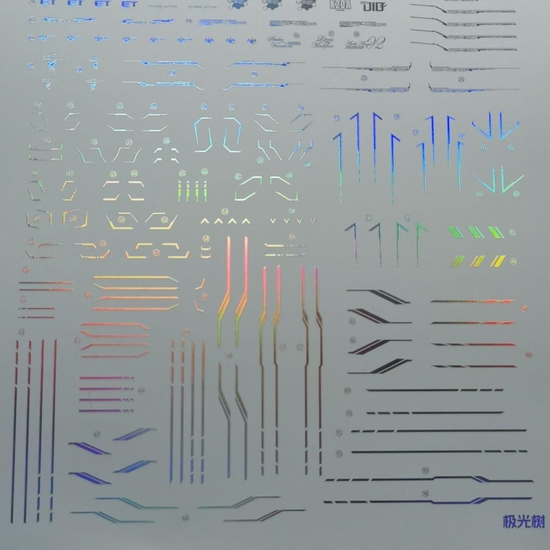 May include: A sheet of iridescent stickers with various geometric shapes and lines. The stickers feature a range of colors, including blue, green, pink, and gold. Some stickers have text, and the overall design is futuristic.