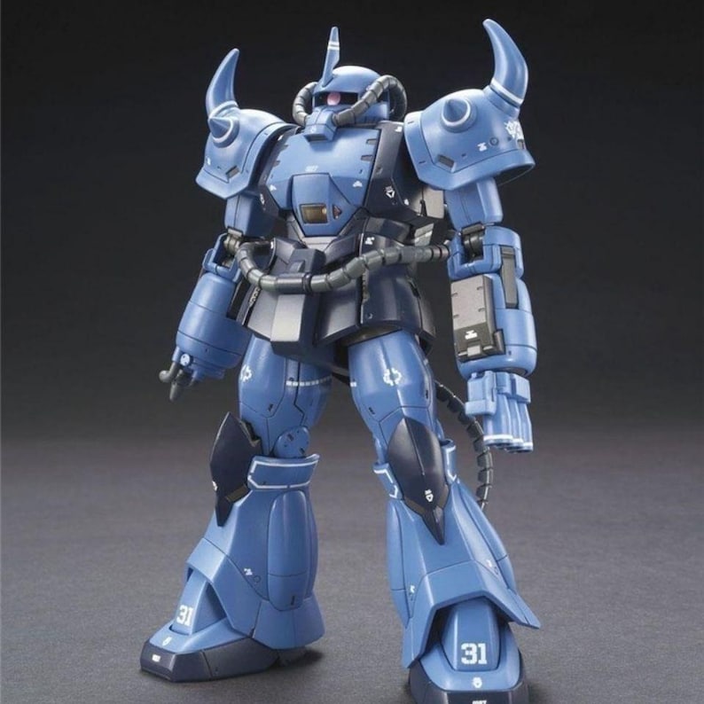 May include: A blue and dark blue robot action figure featuring prominent shoulder spikes, a mono-eye sensor, and a tube-fed power system. The figure displays the number 31 on its feet, articulated joints, and a detailed mechanical armor design.