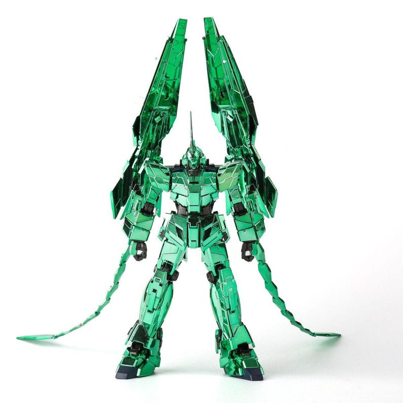 May include: A metallic green robot model with articulated limbs and large, wing-like structures extending upwards. The robot has a horn-like antenna and two long, segmented tails. The model is set against a white background.
