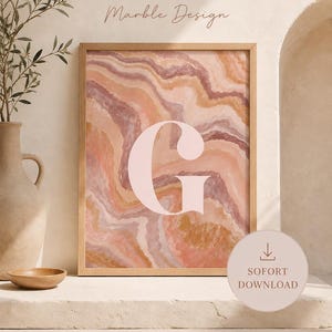 May include: A framed wall art print featuring a large, pale pink letter G centered over an abstract marble pattern in shades of peach, terracotta, and cream. The text WANDDEKO, Marble Design, and SOFORT DOWNLOAD are visible on the print and overlay.