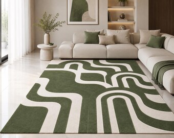 Può includere: Un tappeto rettangolare caratterizzato da un audace motivo geometrico ripetitivo composto da spesse linee curve intrecciate di colore verde oliva e crema. Il design è formato da forme continue e fluide che creano un effetto visivo.