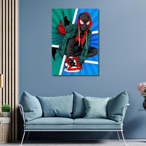 May include: A rectangular wall art print featuring a stylized illustration of a masked character in a black and red suit, wearing a green hooded jacket and red and white sneakers, set against a vibrant green and blue comic book style background.