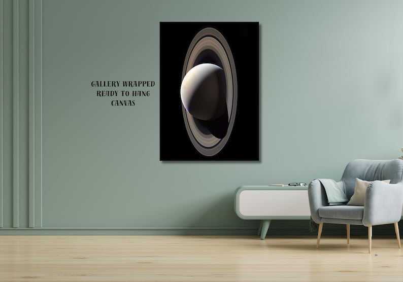 May include: A rectangular gallery wrapped canvas print featuring a vertical depiction of the planet Saturn with its prominent rings against a solid black background. The text "GALLERY WRAPPED READY TO HANG CANVAS" is printed in black on the left side.