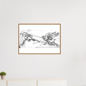 May include: A framed black and white ink drawing titled Atelier Leitherer, depicting two figures pulling a rope in opposite directions on a rocky landscape. The artwork is displayed in a brown frame and mounted on a plain white wall above a sofa.