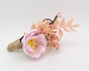 Floral boutonniere in pink with gypsophila