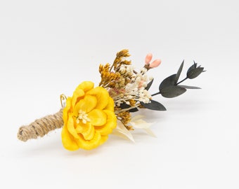 Floral boutonniere in yellow, ivory and mustard with eucalyptus