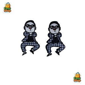 May include: Two embroidered patches featuring a cartoon figure in a black suit, sunglasses, and a checkered blue and white outfit. The patches are on a white background. The figure is in a dancing pose.