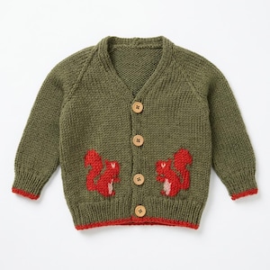 May include: An olive green knit cardigan featuring a V-neckline, long sleeves, and four light brown wooden buttons down the center. The front displays two red squirrel motifs, while the sleeve cuffs and bottom hem are trimmed in bright red.