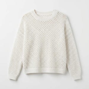 May include: A cream-colored, open-knit sweater with a crew neck and long sleeves. The sweater has a textured, net-like pattern throughout the body and sleeves. The cuffs and hem are ribbed. The sweater is a neutral color and appears to be made of a soft material.