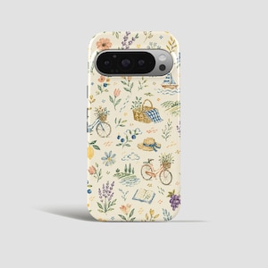 May include: A phone case with a cream background featuring a watercolor design of a picnic scene. The design includes bicycles, flowers, a picnic basket, a sailboat, and a book. The case has a camera cutout.