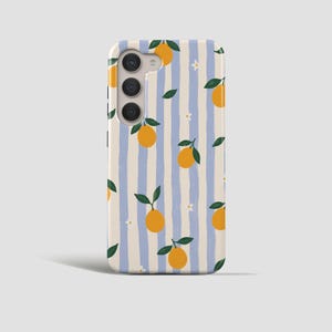 May include: A phone case featuring a pattern of oranges, green leaves, and small white flowers set against vertical blue and cream stripes. The case has a camera cutout.