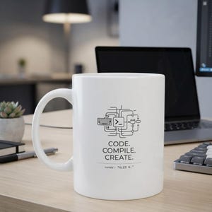 May include: A white ceramic mug featuring a black graphic of a keyboard, a command prompt icon, and a database symbol connected by lines. Below the graphic, the text reads: CODE. COMPILE. CREATE. and owner: "ALEX M." in a clean, sans-serif font.