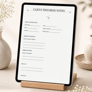 May include: A digital tablet displaying a Client Progress Notes form with sections for Client Information, Session Overview, and Observations. The screen features black text on a white background, including lines for data entry and a small leaf icon.