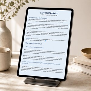 May include: A tablet computer on a stand displaying a FAST Skill Worksheet. The document text explains DBT interpersonal effectiveness, defining the acronym as Fair, No Apologies, Stick to values, and Truthful, with a blue heart icon at the end.