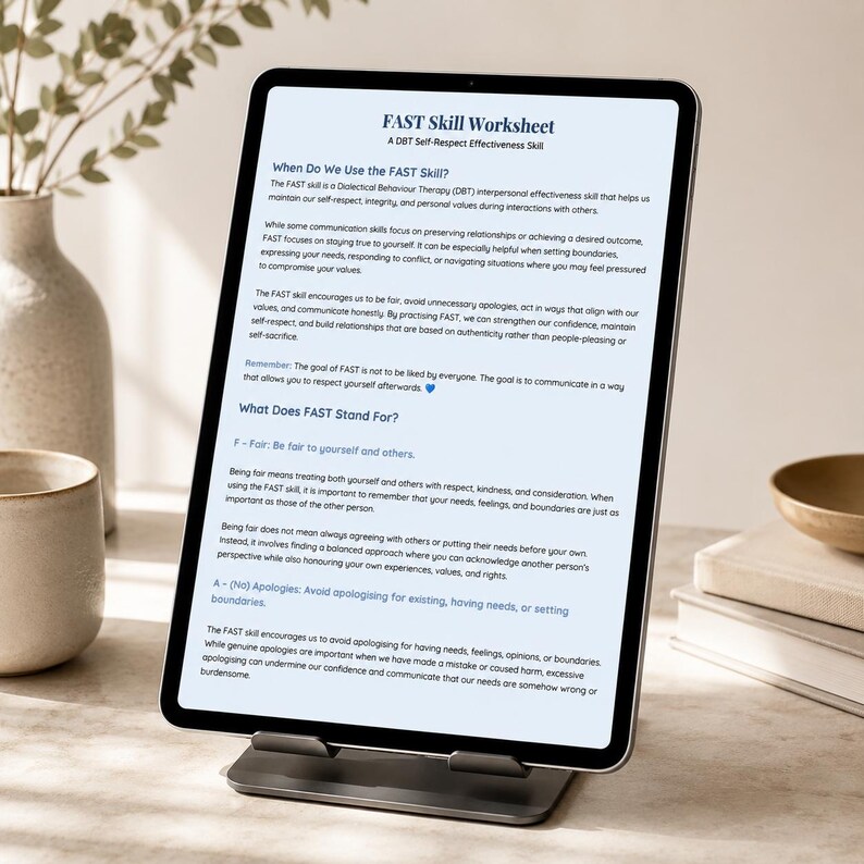 May include: A tablet computer on a stand displaying a FAST Skill Worksheet. The document text explains DBT interpersonal effectiveness, defining the acronym as Fair, No Apologies, Stick to values, and Truthful, with a blue heart icon at the end.