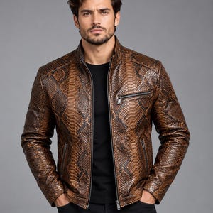 May include: A brown and black snakeskin-patterned jacket with a stand-up collar, a full-length front zipper, and two zippered chest and side pockets. The jacket is worn over a plain black t-shirt and paired with black trousers.