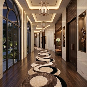 May include: A long hallway featuring a plush runner rug with a repeating circular pattern in shades of cream, brown, and black. The corridor includes dark wood flooring, arched windows, recessed wall niches with sculptures, and hanging metal lanterns.