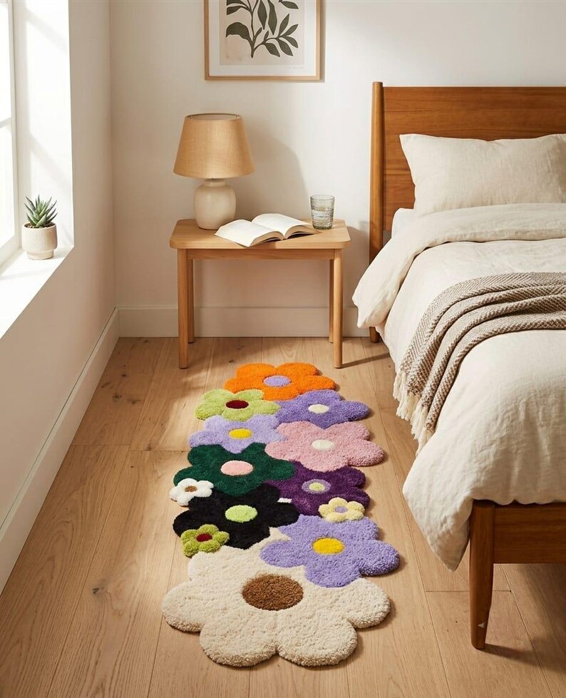 May include: A runner rug featuring a cluster of tufted flowers in various colors including orange, light green, lavender, dark green, pink, purple, black, and cream. Each flower has a contrasting center, creating a vibrant, multi-colored floral pattern.