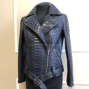 May include: A dark blue motorcycle jacket featuring a textured snakeskin pattern, a wide notched collar, silver-tone metal zips, and a matching buckled belt at the waist. The text "GenuinePythonJacket" is visible across the chest area.