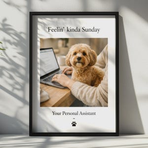 May include: A black framed wall art print featuring a photograph of a light brown dog sitting next to a person using a laptop. The text reads Feelin' kinda Sunday at the top and Your Personal Assistant with a small black paw print icon below.