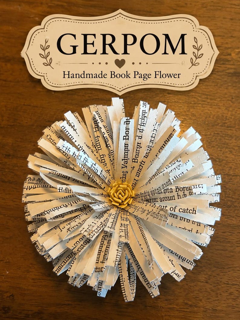 May include: A decorative flower crafted from strips of printed book pages with black text, featuring a small yellow center. Above the flower is a cream-colored label with a decorative border containing the text GERPOM Handmade Book Page Flower.