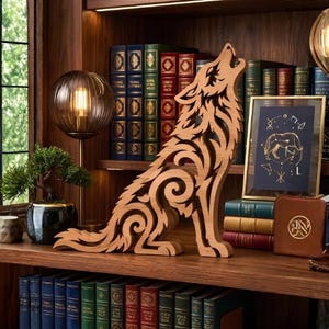 May include: A light brown wooden sculpture of a howling wolf featuring intricate cut-out scrollwork patterns. The wolf is depicted in a seated position with its head tilted upward, showcasing a layered design that creates depth and texture.