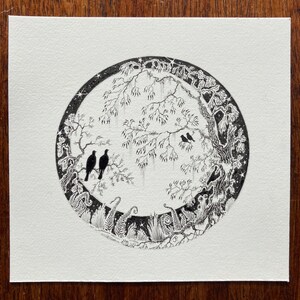 May include: Black and white ink drawing of a circular scene with a tree, birds, and foliage. The scene is surrounded by a border of stars.