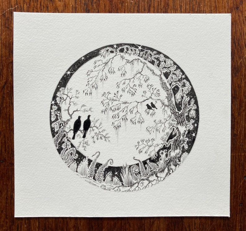 May include: Black and white ink drawing of a circular scene with a tree, birds, and foliage. The scene is surrounded by a border of stars.