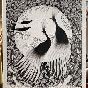 May include: Black and white illustration of two crowned cranes with long, flowing tail feathers, perched on a branch. The background features a full moon, trees, and three birds, all rendered in intricate detail.