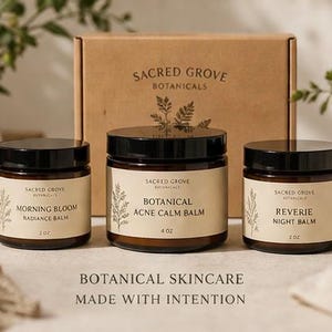May include: Three glass jars with black lids and cream labels are displayed in front of a cardboard box. The jars contain botanical skincare products, including a radiance balm, acne calm balm, and night balm. The text "BOTANICAL SKINCARE MADE WITH INTENTION" is at the bottom.