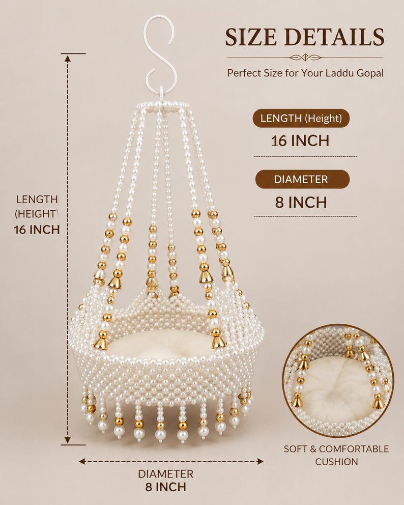 May include: A hanging swing for a Laddu Gopal idol, crafted from white faux pearls and gold-toned beads. It features a circular base with a soft white cushion, measuring 16 inches in height and 8 inches in diameter, suspended by a white metal S-hook.