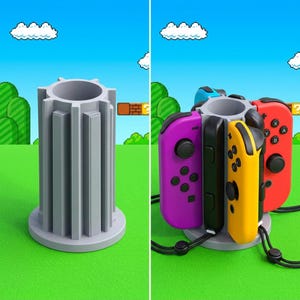 May include: A gray plastic game controller stand with a cylindrical design. The stand holds multiple colored game controllers, including purple, yellow, and red. The background features a video game scene with green hills and a blue sky.