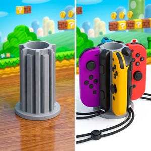 May include: A gray, cylindrical game controller stand with vertical grooves. The stand holds purple, yellow, and red game controllers. The background features a video game scene with green hills, question mark blocks, and coins.