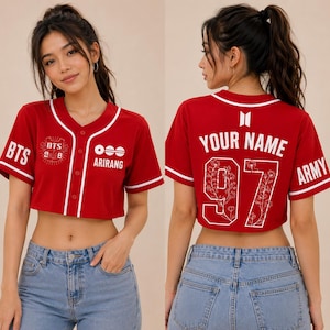 May include: A red cropped baseball jersey with white trim, featuring the text BTS, ARIRANG, and a logo on the front. The back displays the text YOUR NAME, the number 97 with a floral pattern, the BTS logo, and the word ARMY on the sleeve.