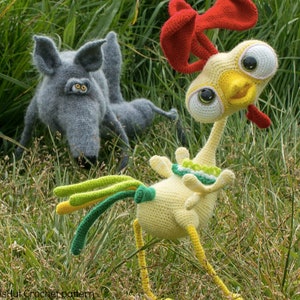 May include: A crocheted yellow chicken with a red comb and green and yellow tail feathers is looking at the camera. A gray crocheted wolf is in the background.