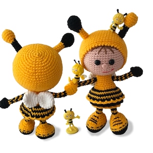 May include: Three crocheted bee toys. Two are larger and have black and yellow stripes. One is smaller and yellow with black stripes. The larger bee toys have white wings and black eyes.