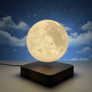 May include: A levitating moon lamp with a detailed surface, illuminated with a soft glow. The moon hovers above a dark wooden square base. The background features a starry night sky with clouds.