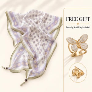 May include: A white and lavender patterned scarf with olive green borders and small dark beads at the corners, accompanied by a gold-toned butterfly scarf ring with white enamel detailing and the text FREE GIFT Butterfly Scarf Ring Included.