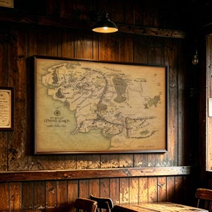 May include: A rectangular framed wall map of Middle-earth with a vintage parchment-style background. The map features detailed black ink illustrations of geographical regions, mountain ranges, and forests, with the text The Map of Middle-earth.