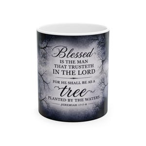 May include: White ceramic mug with a wraparound design featuring the text "Blessed is the man that trusteth in the Lord" and a tree illustration. The mug has a black and white tree and water design, with the Bible verse Jeremiah 17:7-8.
