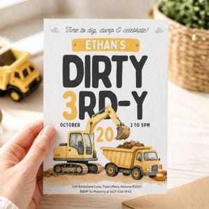 May include: A birthday party invitation with a construction theme. The invitation features a yellow excavator and dump truck, with the text "Ethan's Dirty 3rd-Y". The invitation includes the date, time, and location.