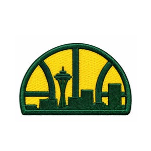 May include: A semi-circular embroidered patch featuring a dark green border and skyline silhouette against a bright yellow background. The design includes the Space Needle and other city buildings framed by arched architectural elements in green.