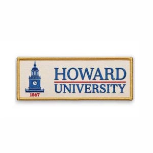 May include: A rectangular embroidered patch with a cream-colored background and a gold-colored border. The patch features a blue graphic of a clock tower on the left and the blue text "HOWARD UNIVERSITY" stacked on the right side.