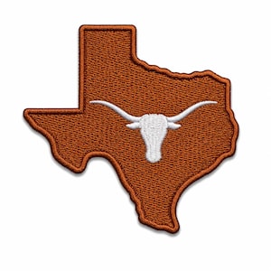 May include: An embroidered patch in the shape of the state of Texas, featuring a burnt orange background with a stitched border. Centered on the patch is a white, detailed silhouette of a longhorn steer head with prominent, curved horns.
