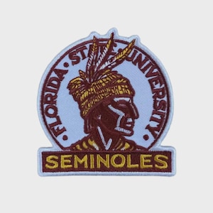 May include: Embroidered patch featuring the Florida State University Seminoles logo. The patch has a white border with the words "FLORIDA STATE UNIVERSITY" in a circular pattern. The central image is a maroon profile of a Seminole warrior with a feathered headdress. The word "SEMINOLES" is embroidered below.