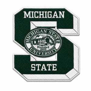May include: A dark green and white embroidered patch in the shape of a block letter S. The word MICHIGAN is stitched at the top, STATE at the bottom, and a circular Michigan State University seal with the text FOUNDED 1855 is in the center.